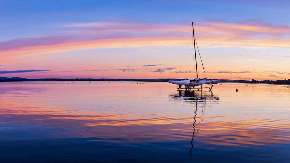 Trimaran dry docked on Brome Lake at sunrise, Quebec Canada