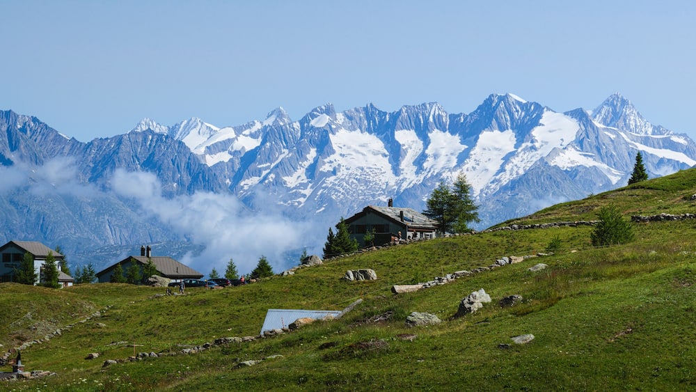 The mountain pastures and small villages among the meadows of the Simplon Pass (Switzerland), during a beautiful summer day - July 2021.
