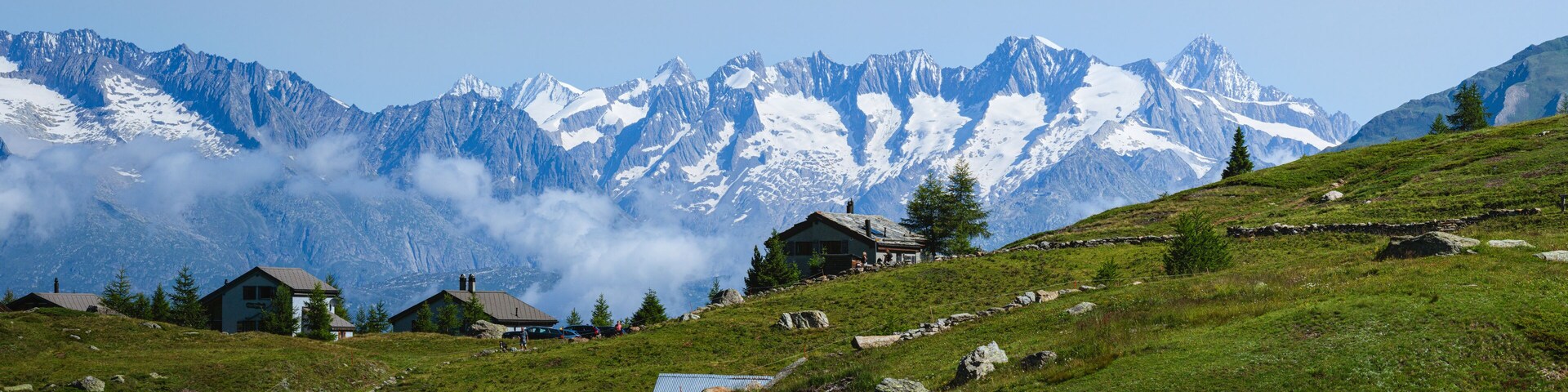 The mountain pastures and small villages among the meadows of the Simplon Pass (Switzerland), during a beautiful summer day - July 2021.