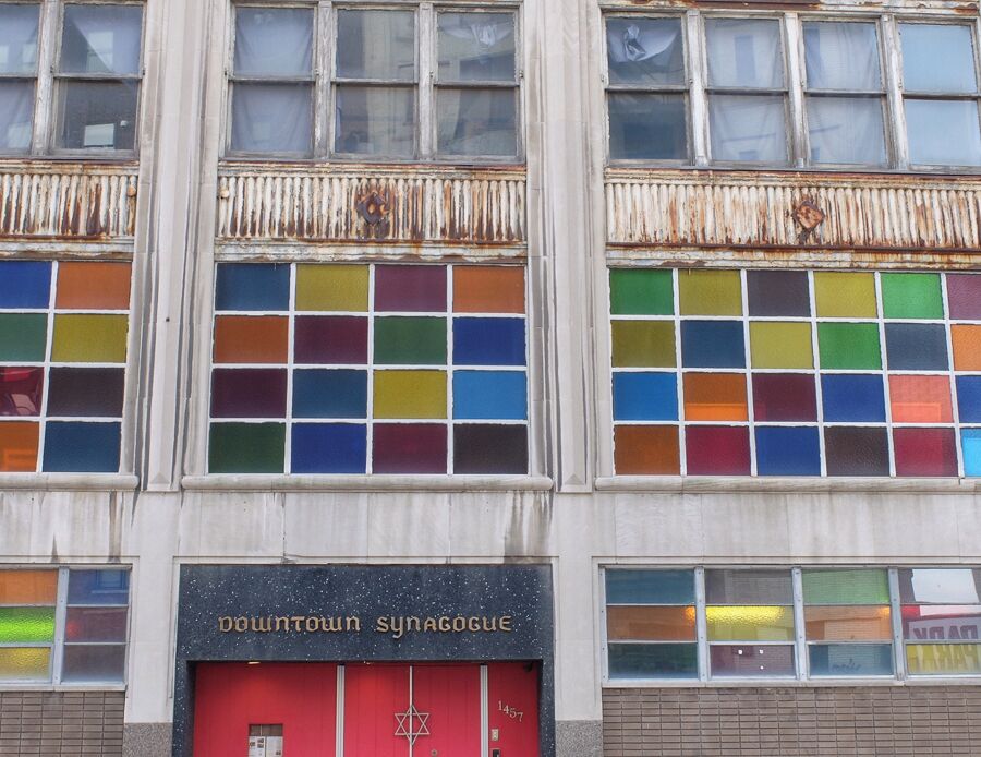 Patrons and staff of the Isaac Agree Memorial Soceity have joined together to revitalize the synagogue in downtown Detroit. This location marks the third home for the synagogue. It's impossible to miss with its colorful windows and bright red door welcoming its congregation. 