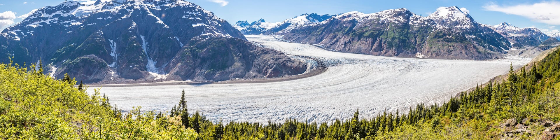 Panorama of Salmon Glacier and a chain of snow covered mountain peaks, Alaska