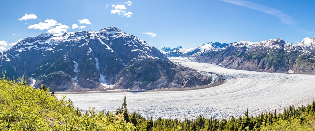 A glacier with mountains in the background.