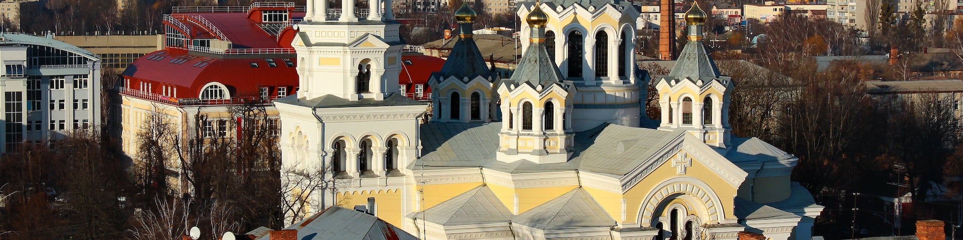 A historic church with multiple spires and domes, surrounded by urban buildings.