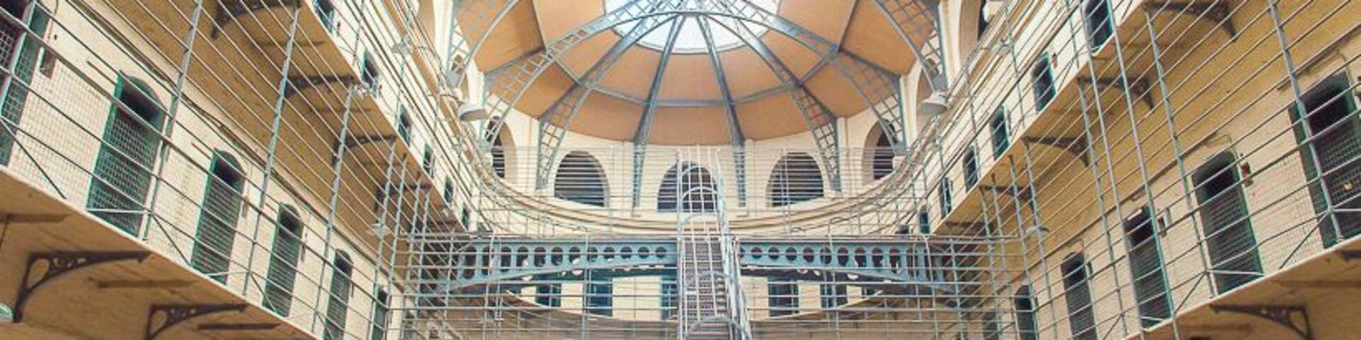 A multi-level atrium with a central staircase and a glass ceiling.