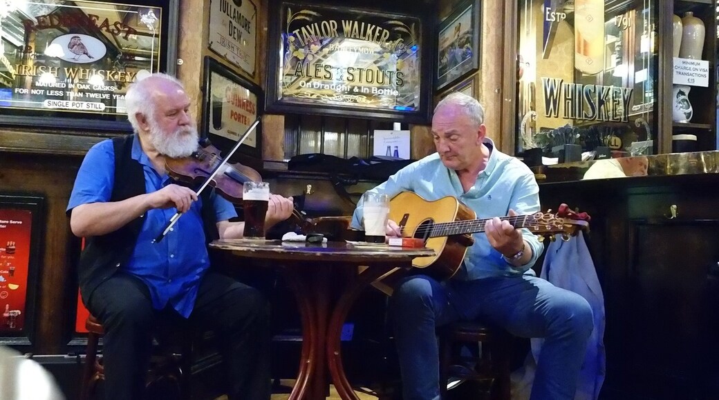 Two musicians playing and hamming it up for for the American tourists.