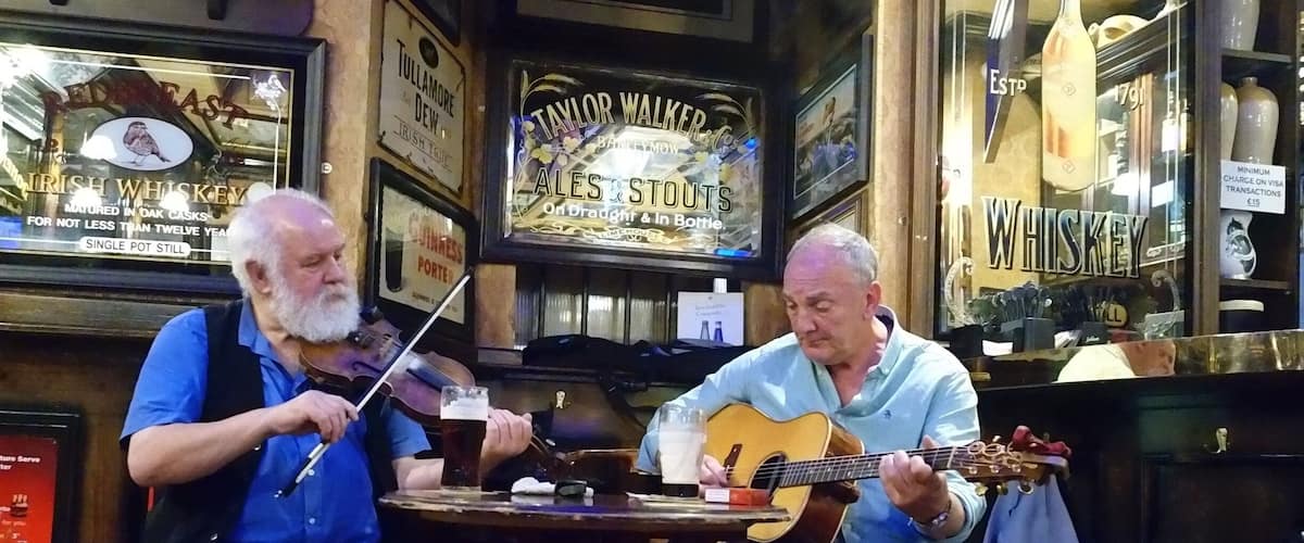 Two musicians playing and hamming it up for for the American tourists.