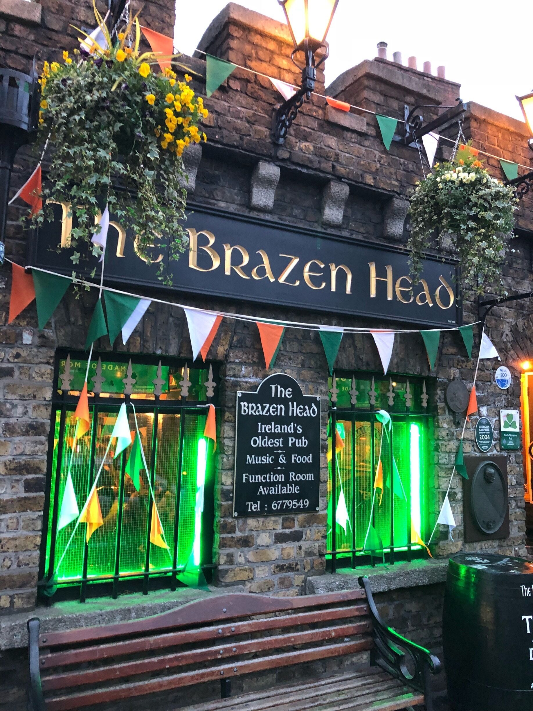 The Brazen Head, a pub with a signboard and green lights.