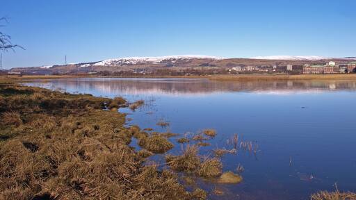 Newshot Island Inlet, River Clyde Looking downstream to the Erskine Bridge. Clydebank hospital on the right. Kilpatrick Hills in the distance.