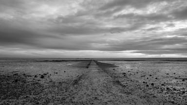 Black and white image of a pathway on the beach at Westcliff, Essex, England, United Kingdom