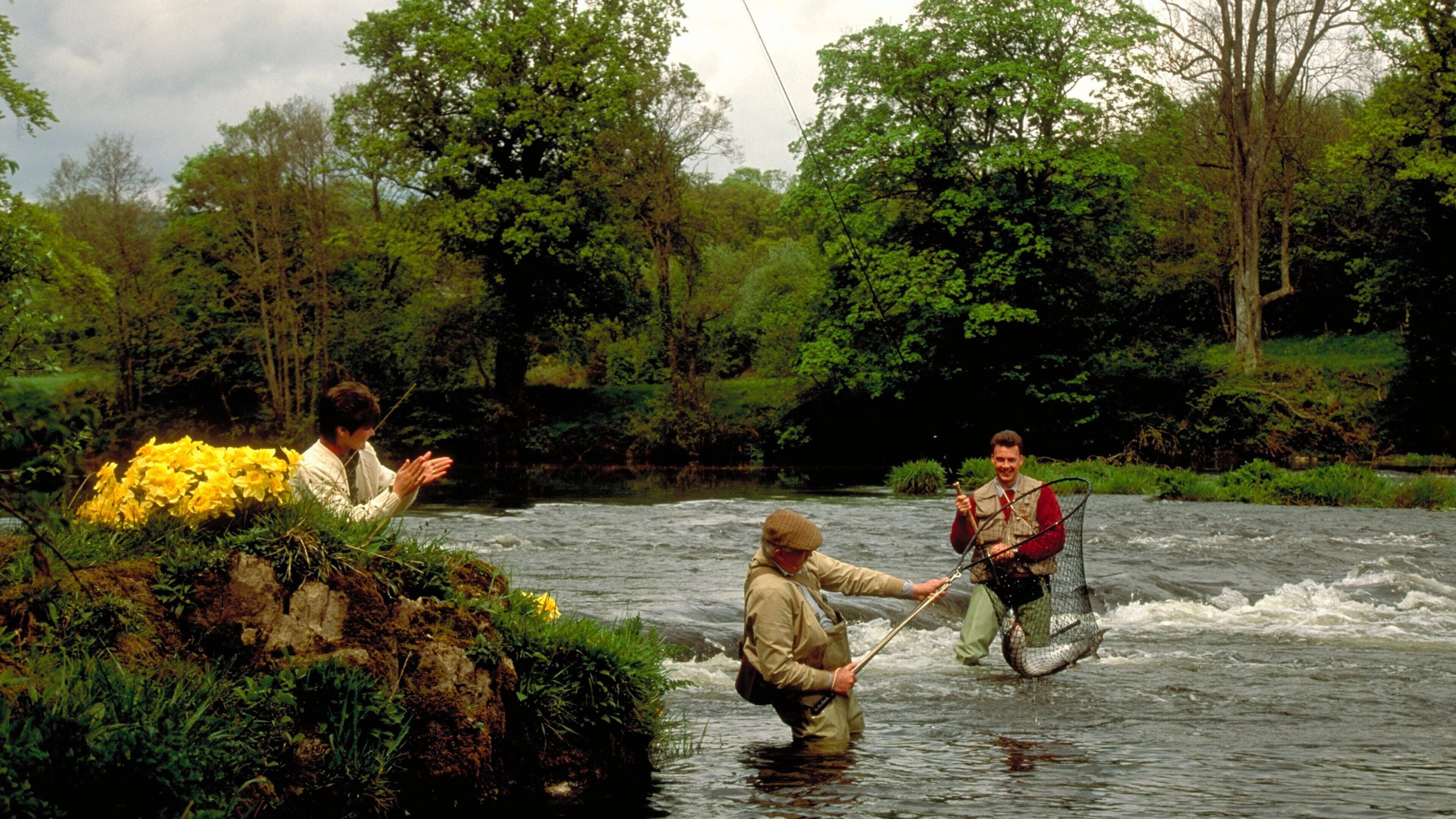 Powys showing a river or creek and fishing as well as a small group of people