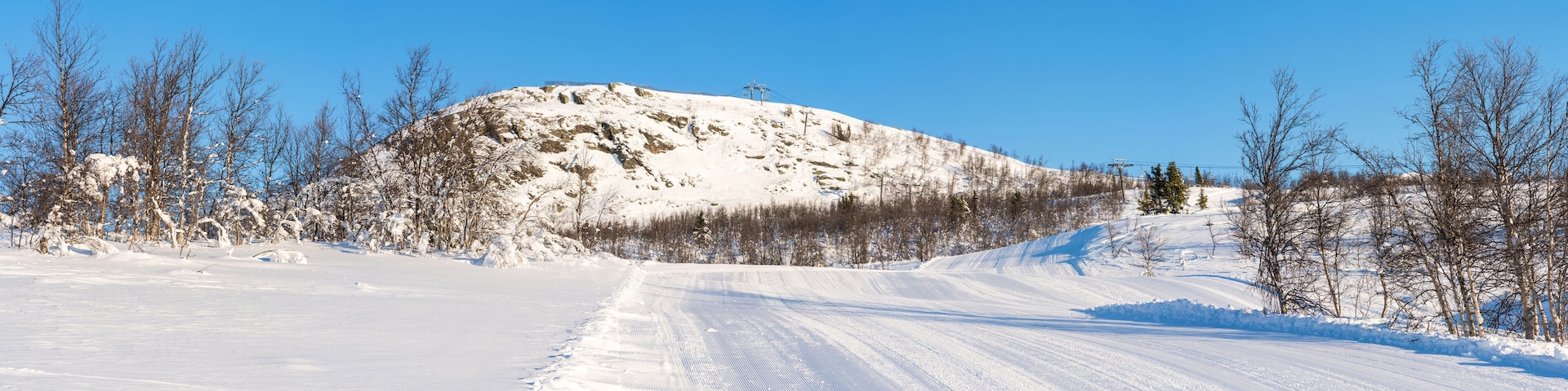 A snow-covered mountain with a clear sky.