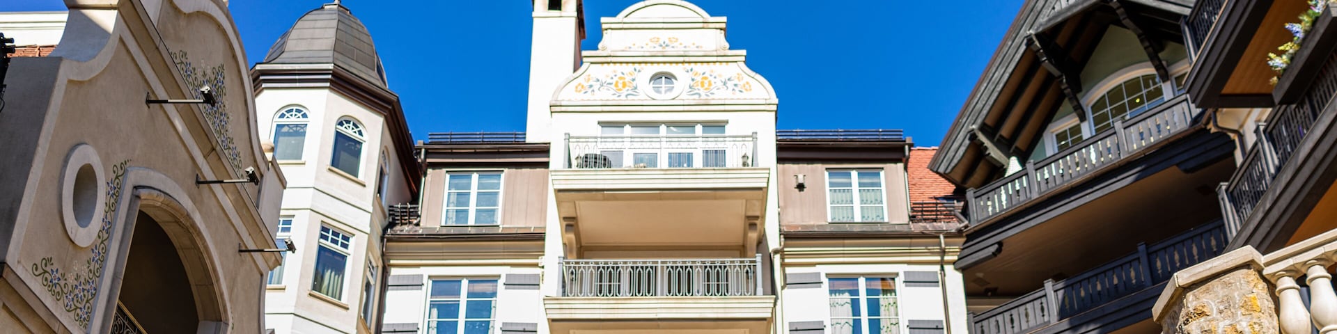 Un edificio de varios pisos con balcones ornamentados y una cúpula.