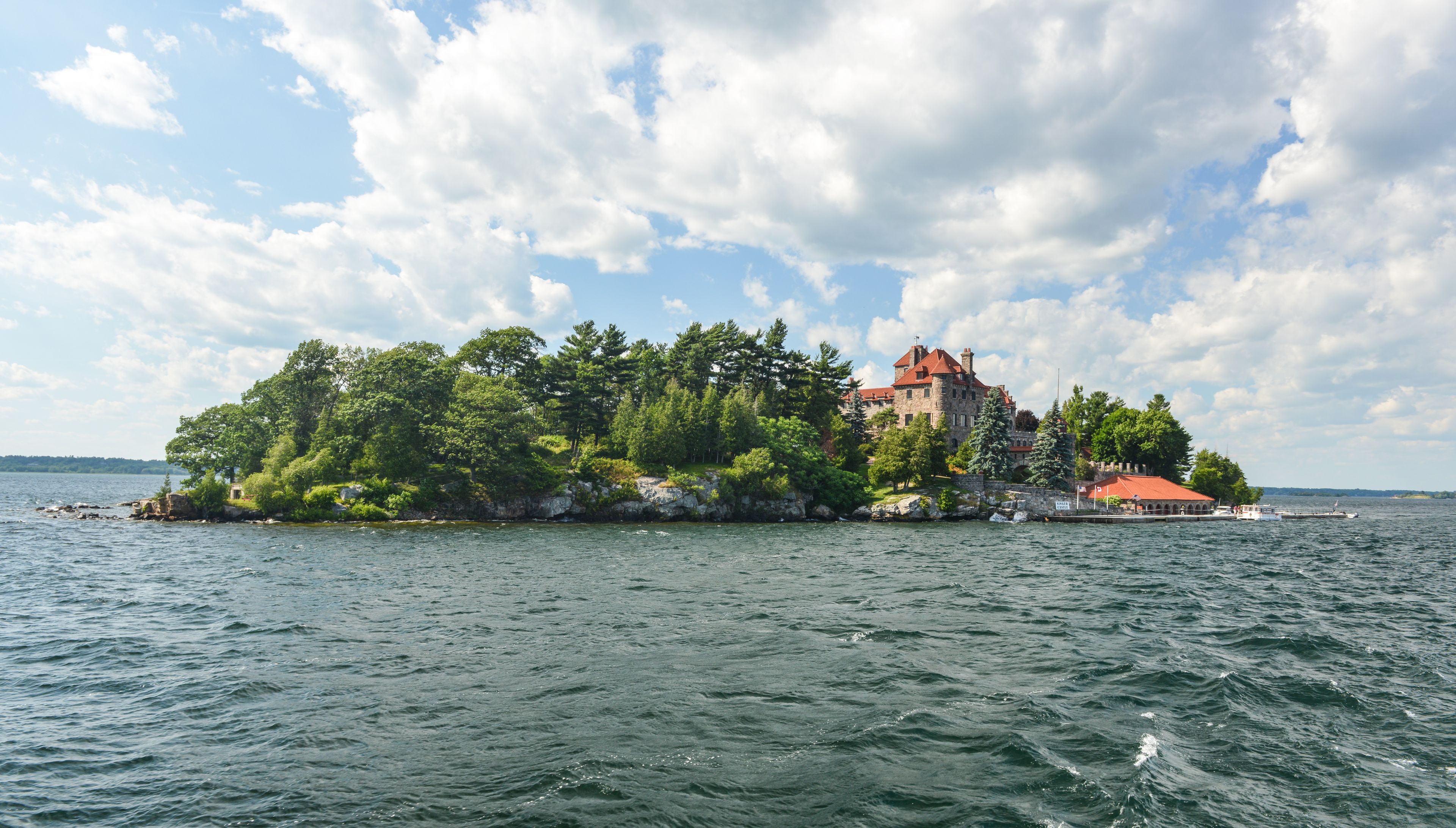 A castle on a small island surrounded by water.