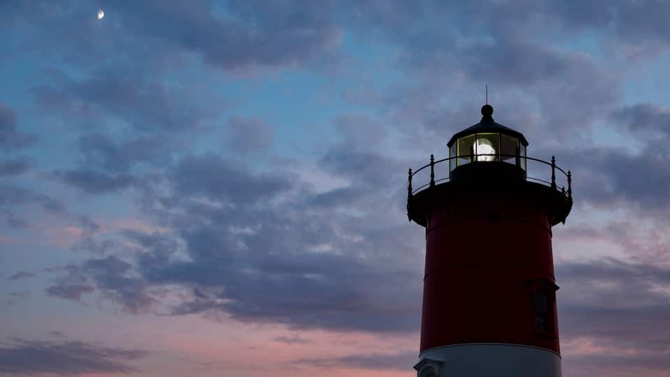A lighthouse against a sunset sky.