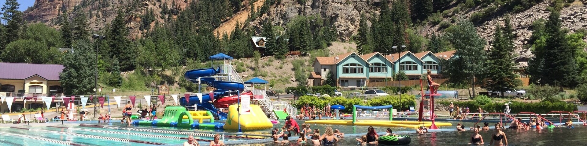 This HUGE public pool incorporates the natural hot springs into a divided group of pools with varying temperatures and activities to suits everyone's needs: a hot soak (104 degrees F), three water slides, an inflatable obstacle course, lap lanes, warm wading pool, water volleyball, water basketball, and 8 foot deep swimming area. To top it off, you can enjoy there stunning views of the gorgeous surrounding geology where the perimeter trail allows you to hike the entire bowl in an easy 1/2 day trip.