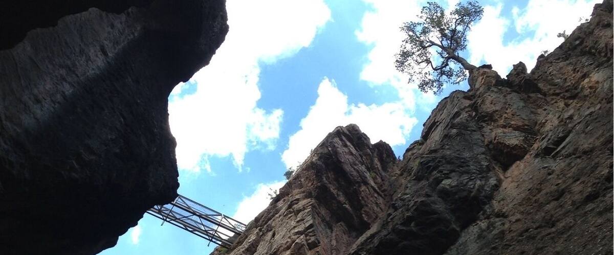 Looking up at the high bridge over Box Canyon, built in 1900 by the Bollen Bridge Company to support water pipes that criss-crossed the canyon where miners searched fruitlessly for gold. It is now a walking bridge that takes you into a tunnel in the side of the canyon wall - all part of an excellent hike along the Ouray perimeter trail.
