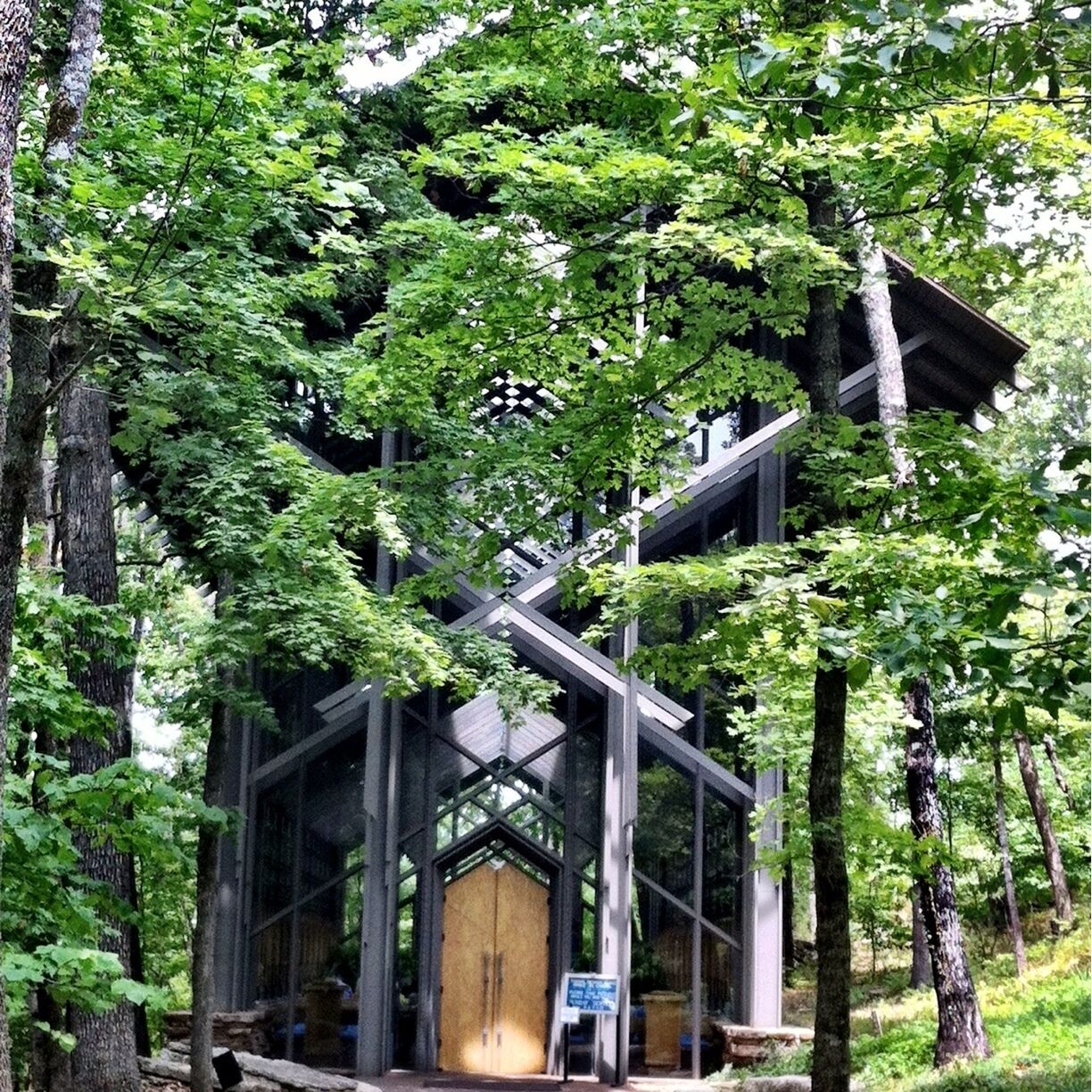 Nestled  in a wooded setting, Thorncrown Chapel rises forty-eight feet into the Ozark  sky. This magnificent wooden structure contains 425 windows and over 6,000  square feet of glass. It rests on over 100 tons of native stone and colored  flagstone. The chapel’s simplicity and majestic beauty make it what critics  have called “one of the finest religious spaces of modern times.”