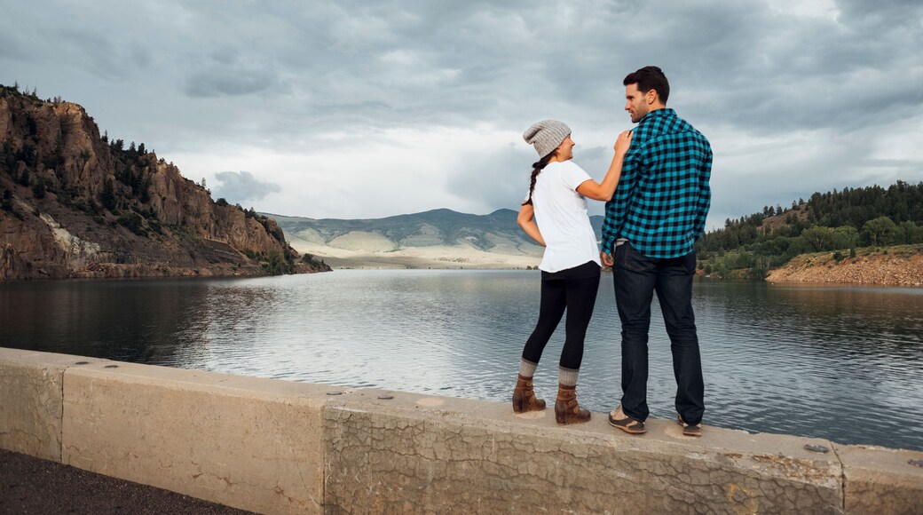 Couple standing on wall beside Dillon Reservoir, Silverthorne, Colorado, USA