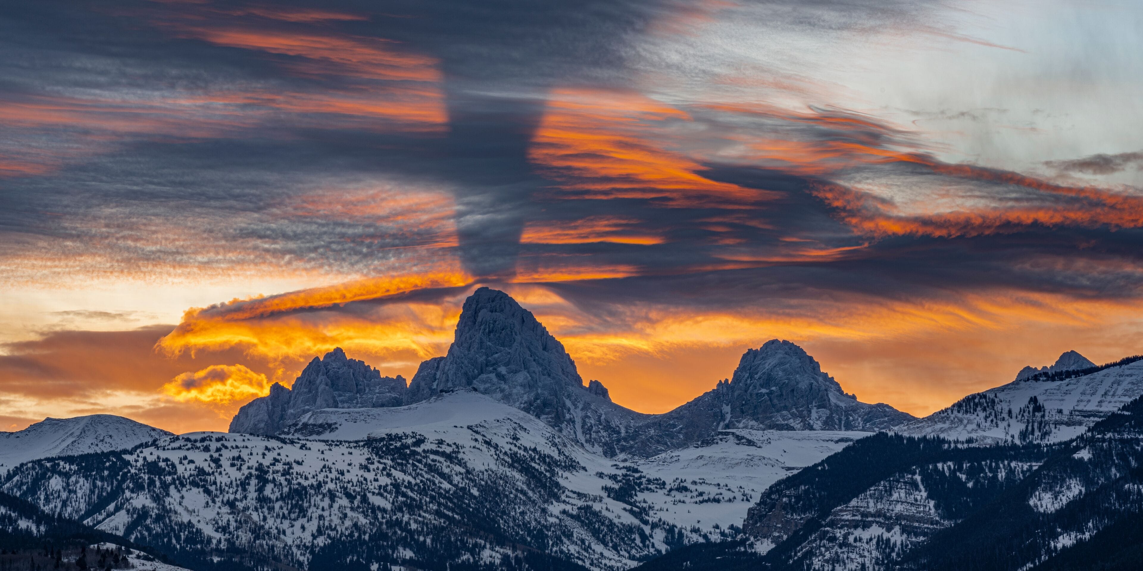 USA, Wyoming. Crepuscular rays over the Teton Mountains at sunrise.