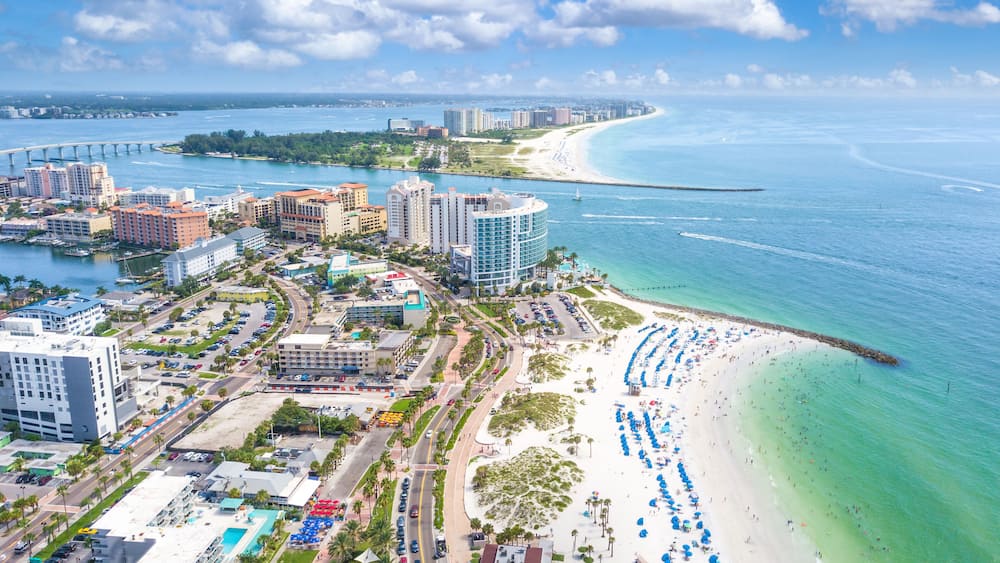 Panorama of city Clearwater Beach FL. Summer vacations in Florida. Beautiful View on Hotels and Resorts on Island. Blue-Turquoise of Ocean water. American Coast or shore Gulf of Mexico. Sunny day.