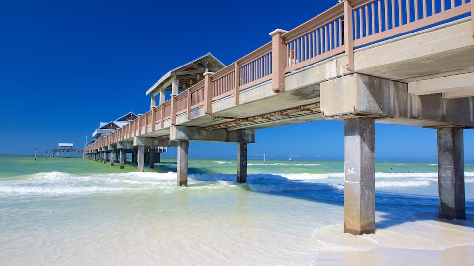 A pier extending into the ocean with clear skies.