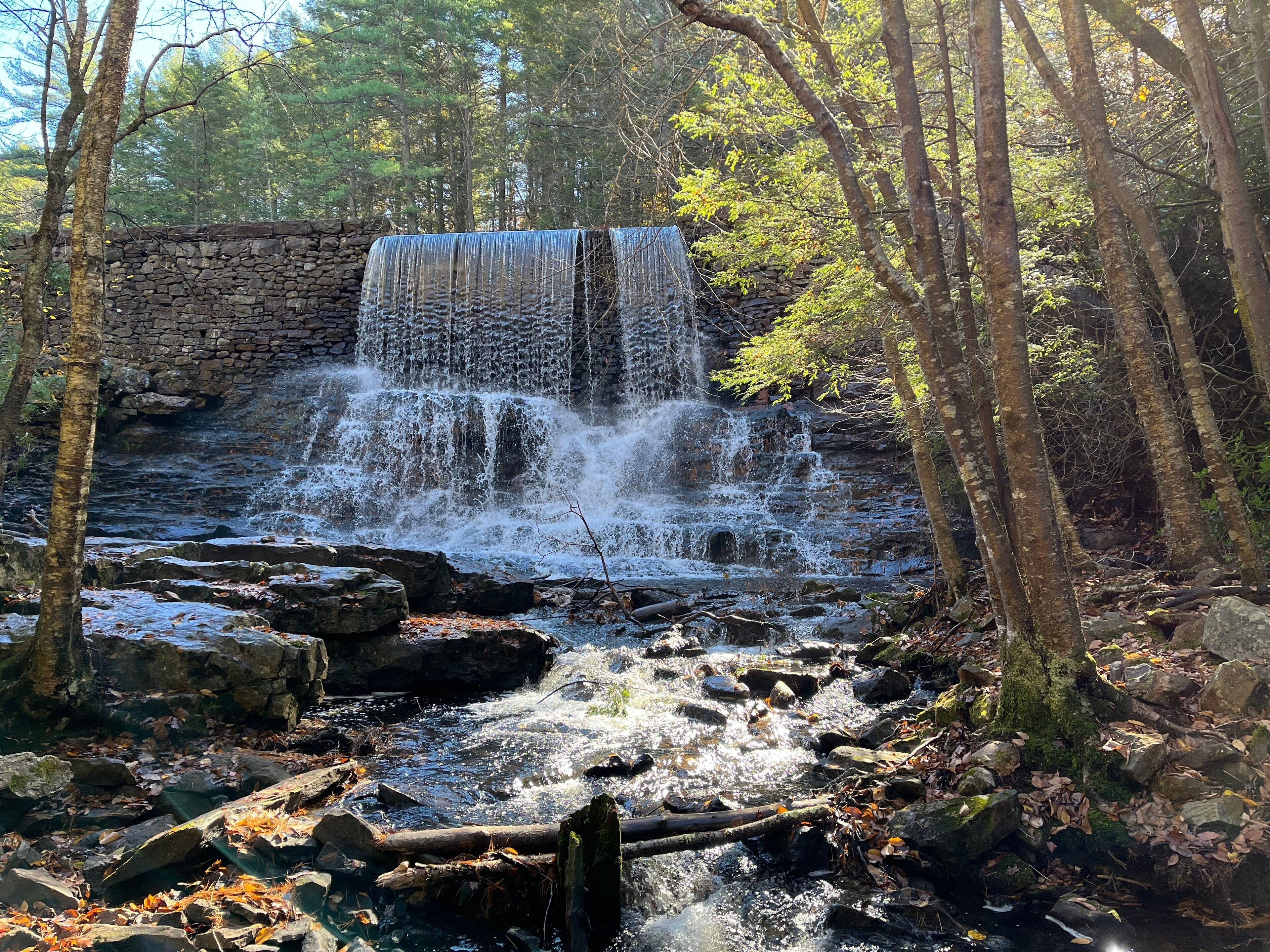 A tranquil scene of the Stametz Dam waterfall on Sand Spring Run, in Hickory Run State Park, Carbon County, White Haven, Pennsylvania.