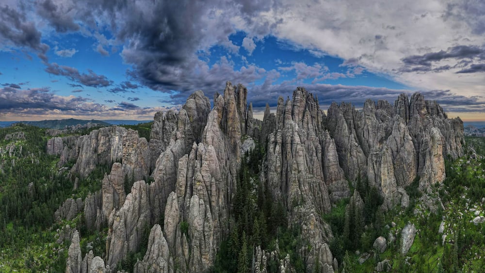 panorama of needles spires with storm clouds in the background off needles highway in black hills of South Dakota