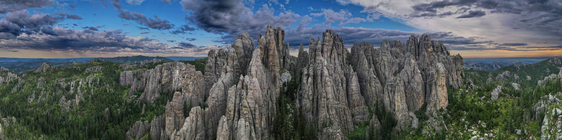 panorama of needles spires with storm clouds in the background off needles highway in black hills of South Dakota
