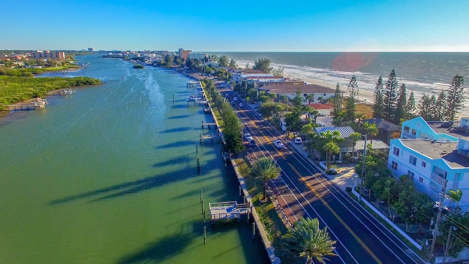 A coastal city with a river, a bridge, and a beach.