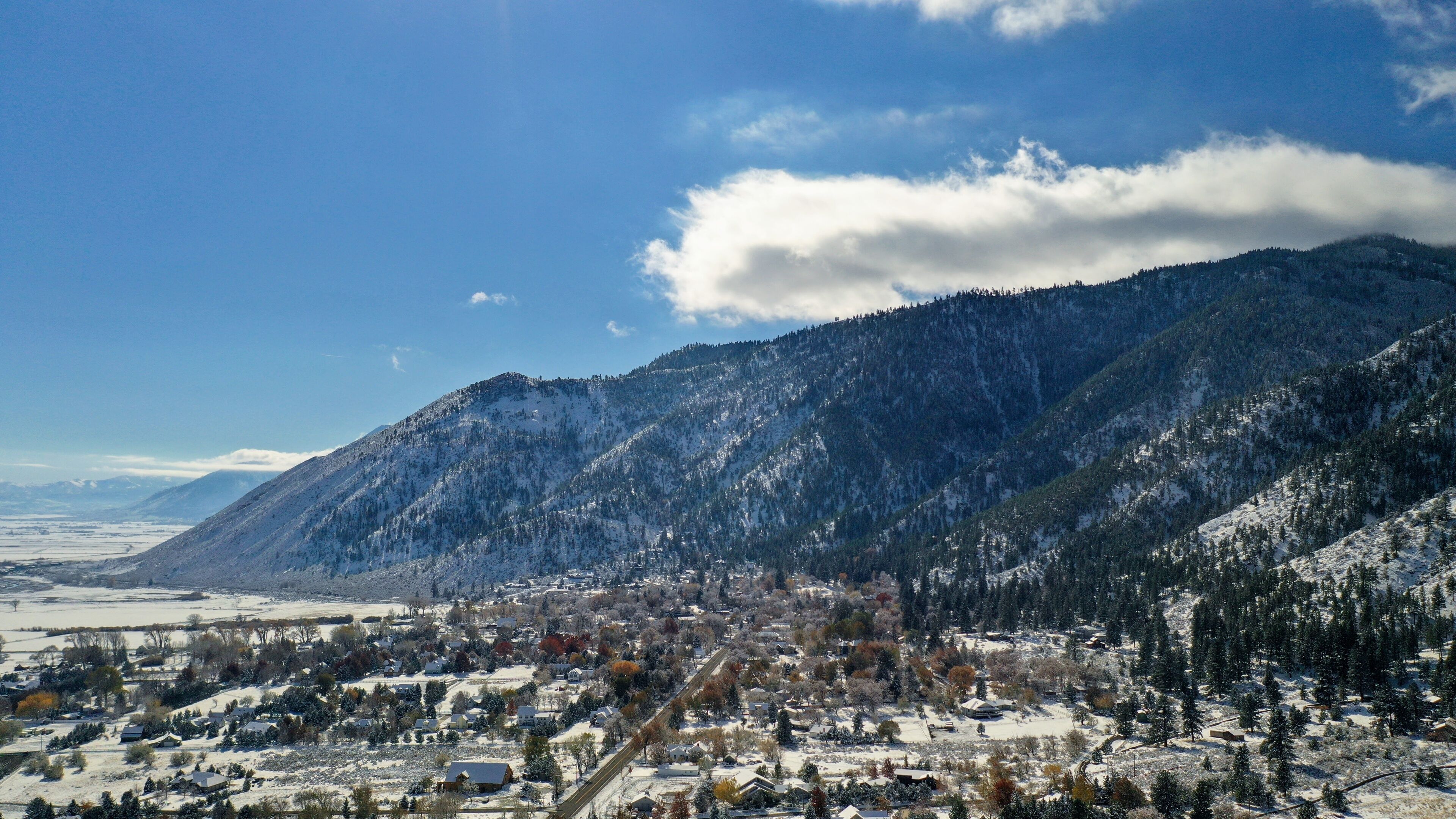 A snow-covered town nestled between mountains.