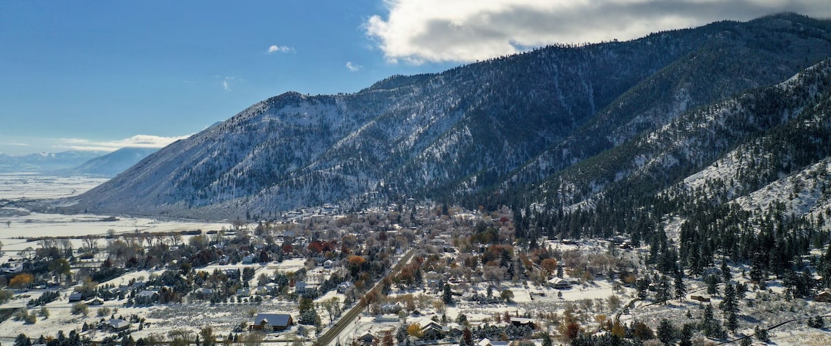 A snow-covered town nestled between mountains.