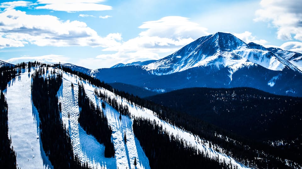 A snow-covered mountain with a clear sky.