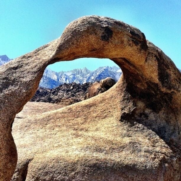 A large rock formation with a natural arch.