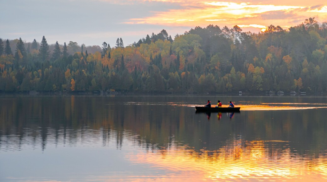 People are boating on Caribou Lake on a fogy morning