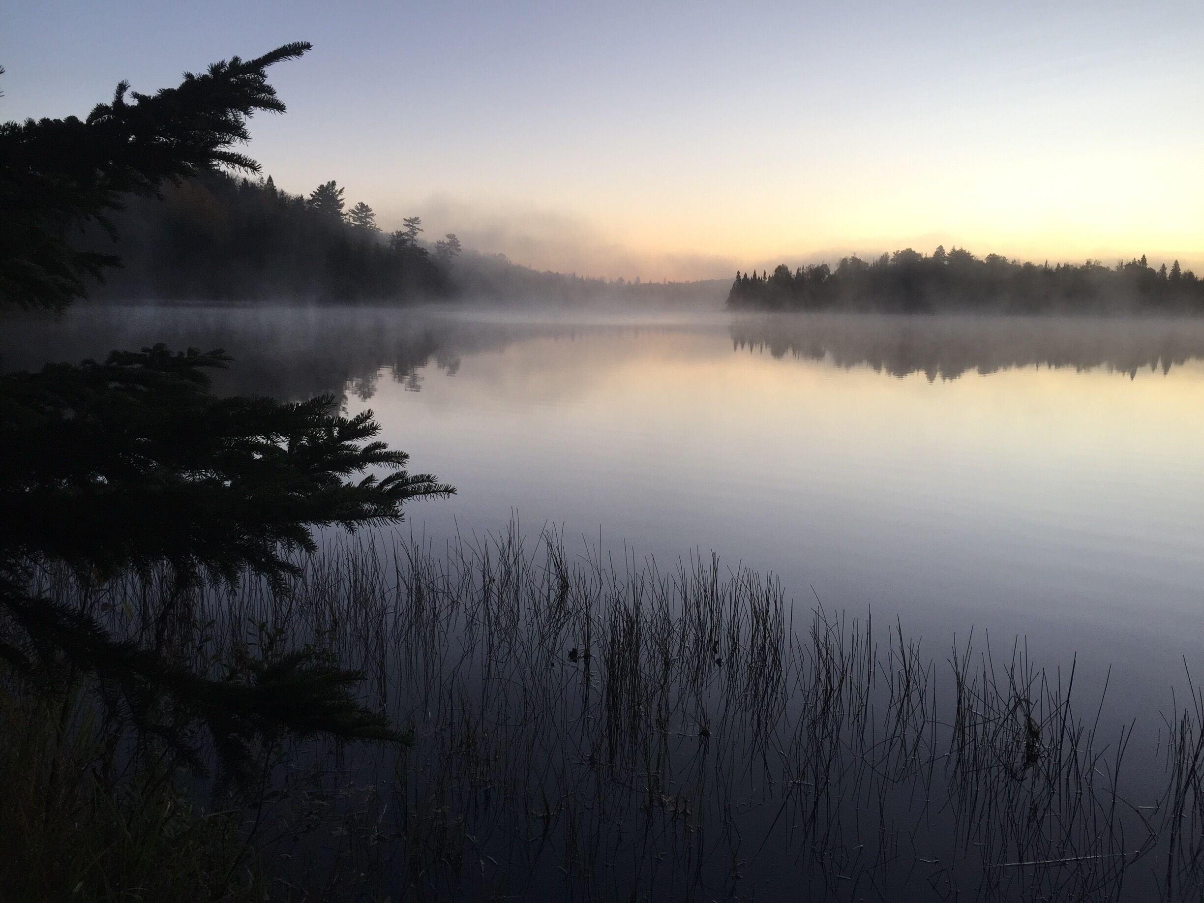 Cold morning sunrise over Lake Agnes while hiking the Superior Hiking Trail.