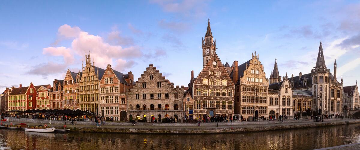 A historic European city with a prominent building featuring a clock tower and intricate architecture.