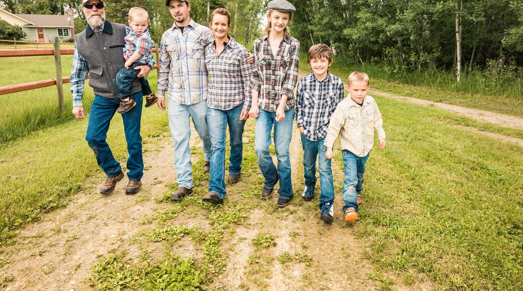Western family walking together down driveway. Red Lodge, Montana, USA