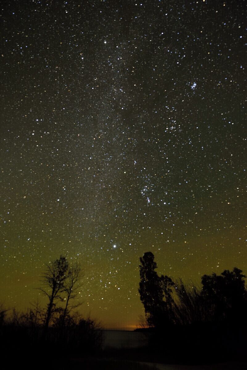 A portrait shot of the night sky with the lake in the foreground. This is a great spot for watching the night sky in door county. 
