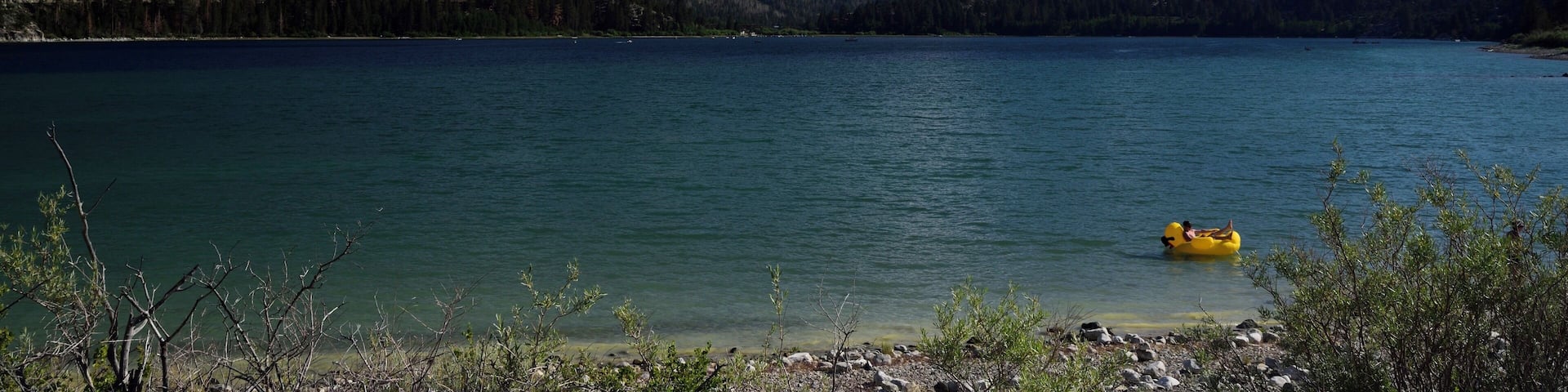 Serene and calm with a great view of mountains across the lake.