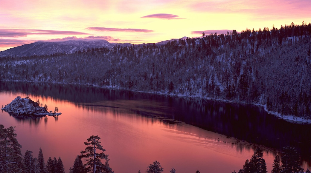 This is Emerald Bay at sunrise after a winter snow storm. There is snow on the land surrounding the bay.