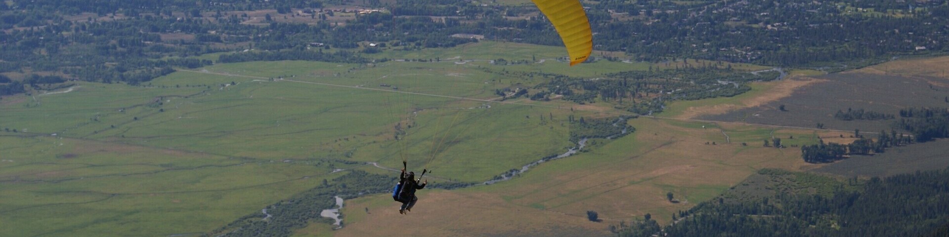 Took the tram to the top of the mountain and noticed a couple guys with large duffel bags. As soon as they got off the tram they ran to a trail leading to the South. They would buy an all day tram pass and after riding up, paraglide back down, tram back up and so on. Pretty cool.