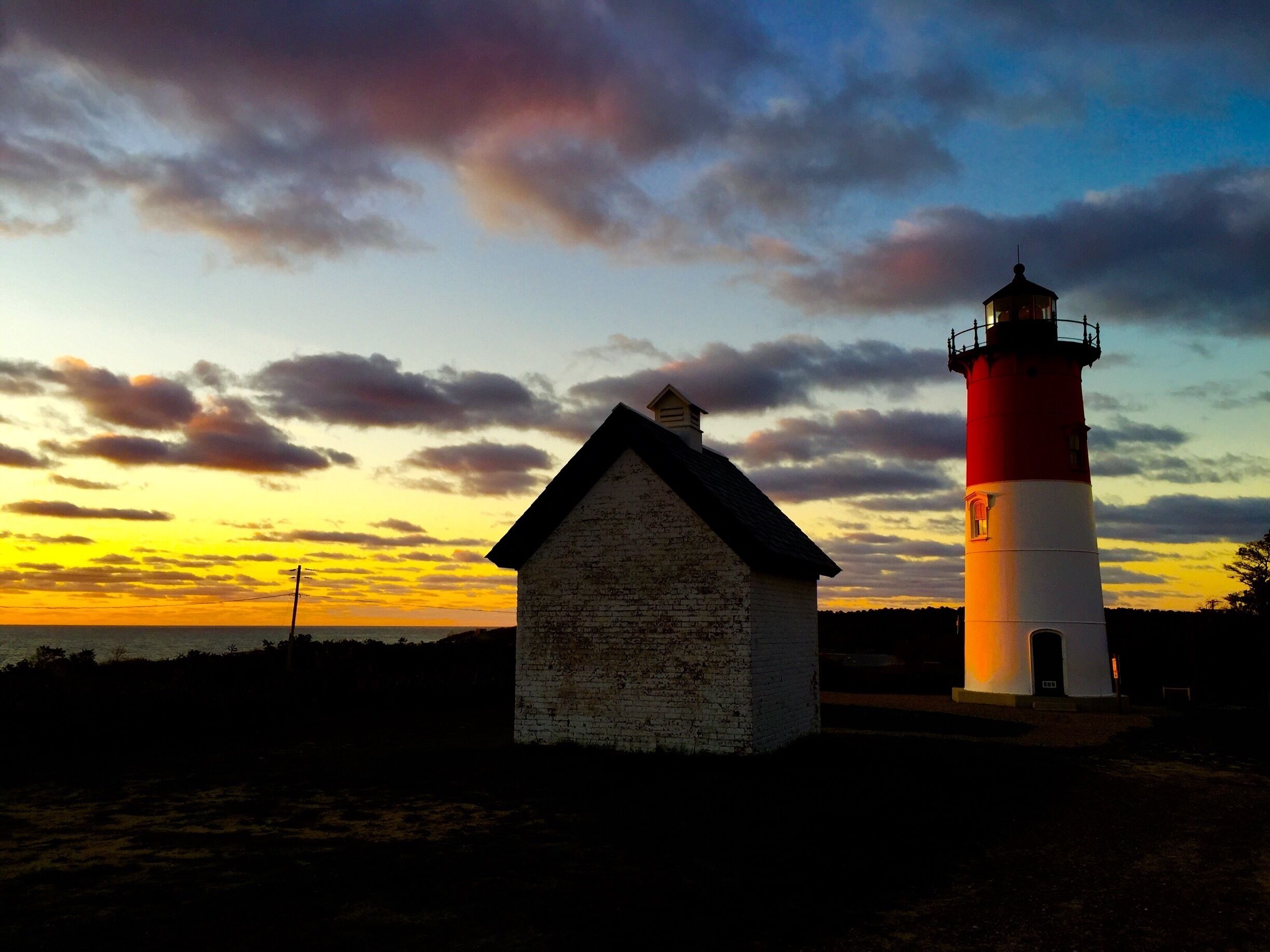 My favorite lighthouse in the world with its beautiful iconic red and white dress- setting high above a cliff - decommissioned but still shining her light - Mauser light- this photo was taken at sunrise as the sun crept above the fierce Atlantic  - eastham, cape cod national seashore #lighthouses