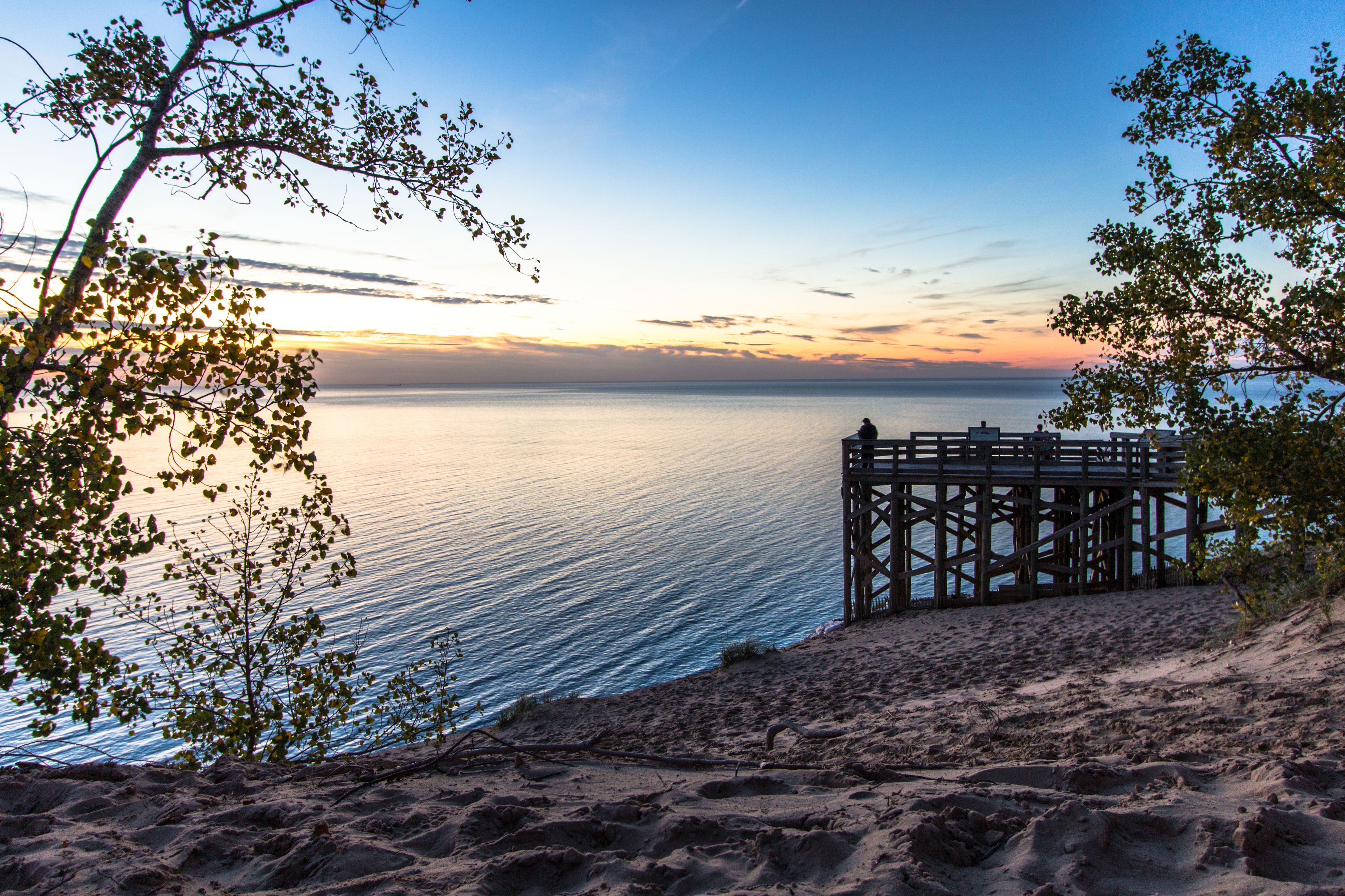 Sleeping Bear Dunes National Lakeshore, Large wooden overlook at sunset with silhouette of tourist admiring the sunset at the famous Sleeping Bear Dunes National Park in Michigan.