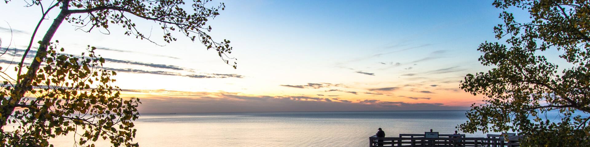 Sleeping Bear Dunes National Lakeshore, Large wooden overlook at sunset with silhouette of tourist admiring the sunset at the famous Sleeping Bear Dunes National Park in Michigan.