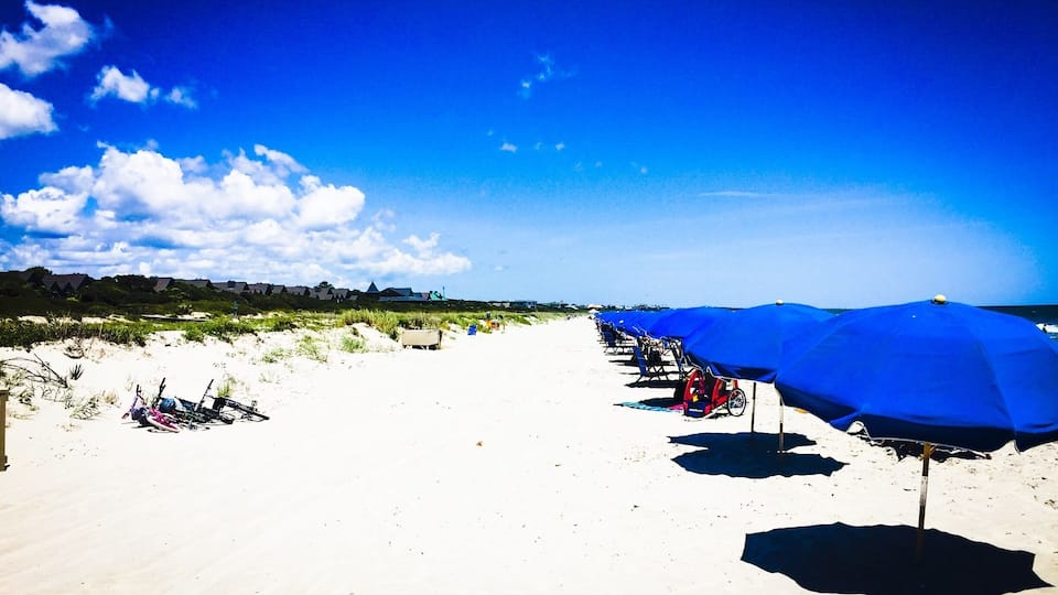 The private part of the beach is the way to go if you can swing it, but the public beach is just as nice. It's just more crowded.