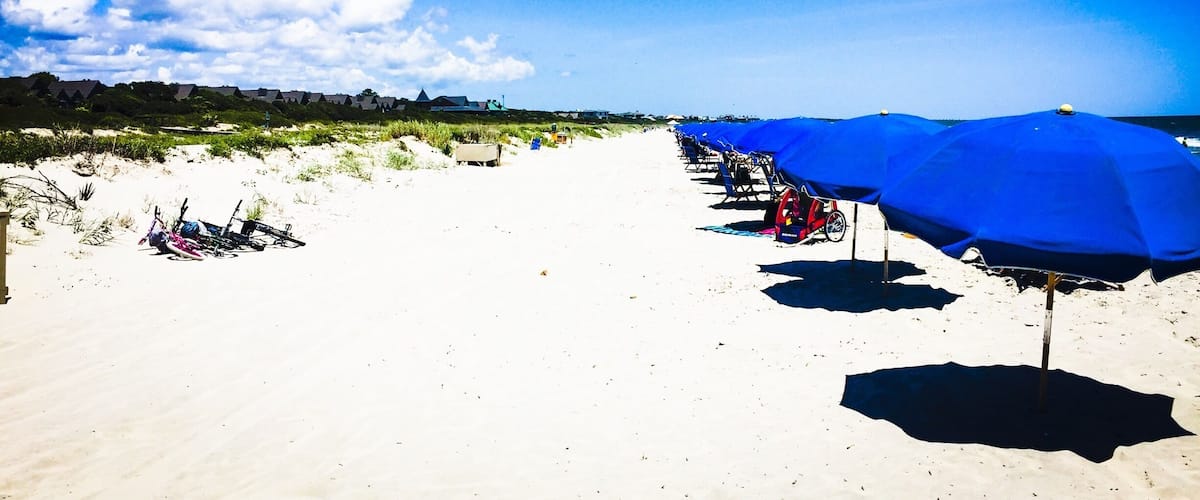 The private part of the beach is the way to go if you can swing it, but the public beach is just as nice. It's just more crowded.