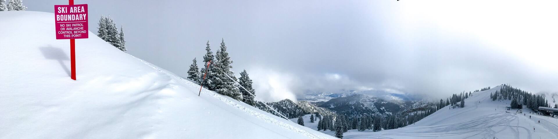 View of the mountains in winter from the edge of the ski area of Alta ski resort in Utah.
