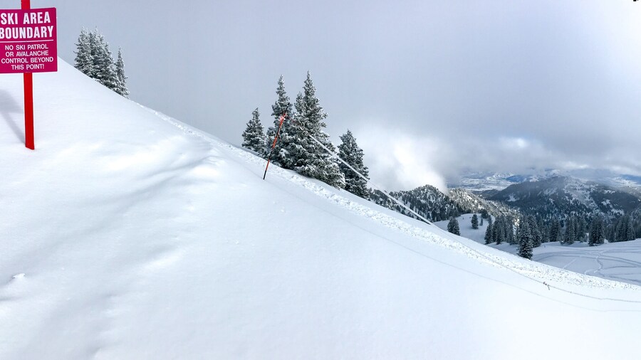 View of the mountains in winter from the edge of the ski area of Alta ski resort in Utah.