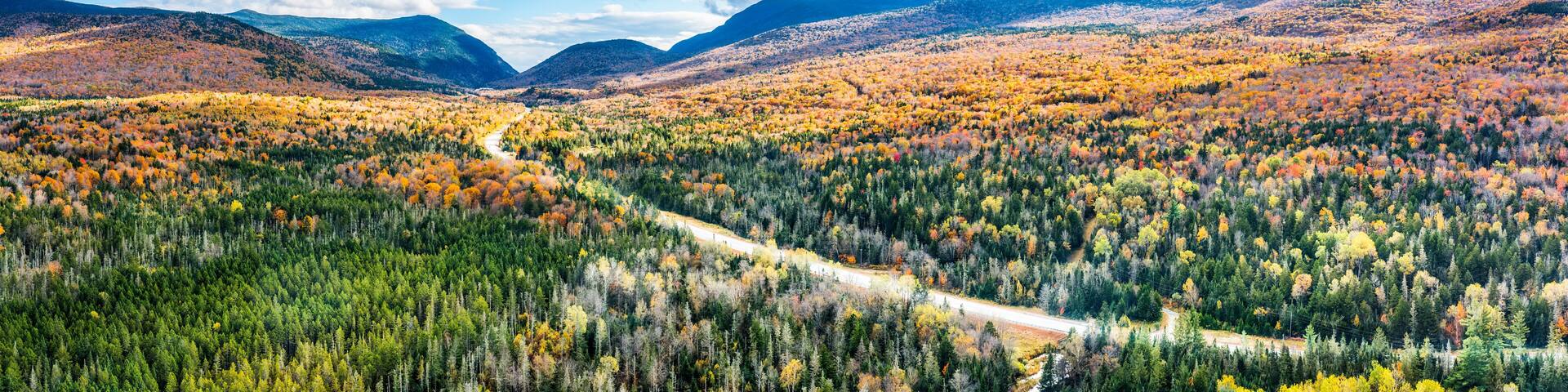 Aerial panorama US route 302 leading to Crawford Notch State park between Mount Webster and Willard. Mt Jackson (left), Willey, Field and Tom (right) are visible in the back.