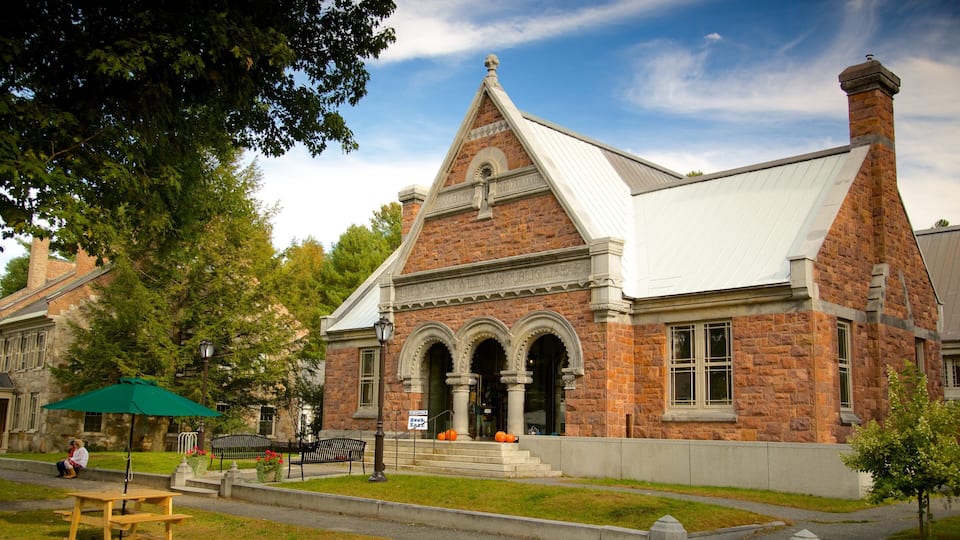 A brick building with a white roof and arched windows, labeled as the Norman Williams Public Library.